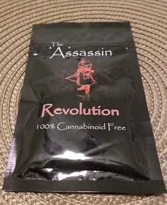 A vibrant package of Assassin Revolution Herbal Incense with incense sticks and a holder, set against a backdrop of serene natural elements, showcasing the product's unique herbal blend.