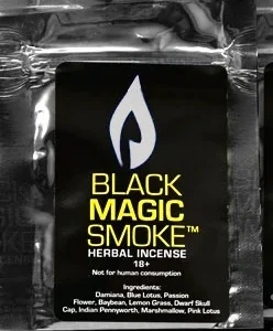 Package of Black Magic Smoke Herbal with aromatic smoke wafting in the background, set against a serene environment, showcasing the blend's calming and enchanting essence